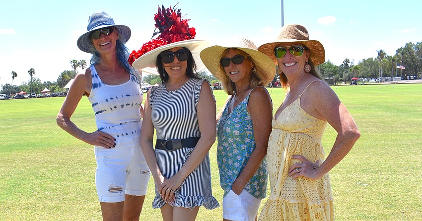 Sarasota's Debby Greer, Sarasota's Nella Travers, Lakewood Ranch's Carol Frazier, and Lakewood Ranch's Tracy Day take a break from tailgating to take a photo.