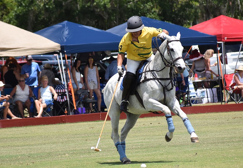 Whisky Pond/Columbus Realty's Guille Aguero drives a shot down the field at the Sarasota Polo Club.
