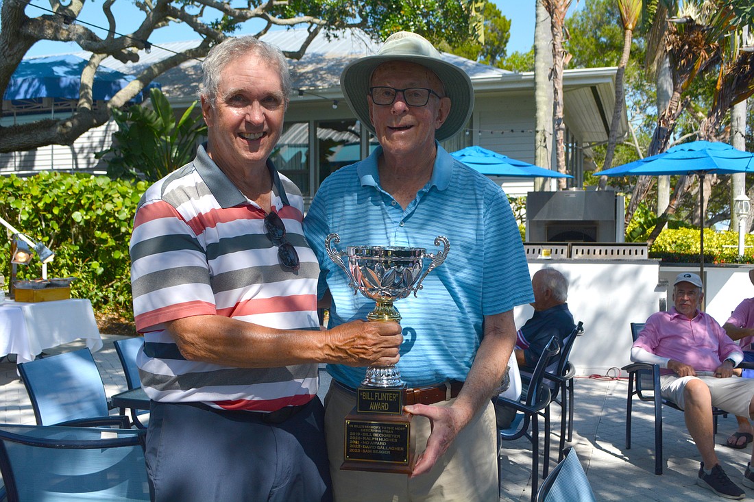 Frank Sulzman, Friars golf group member, presents Sam Seager with the Bill Flinter Memorial Award.