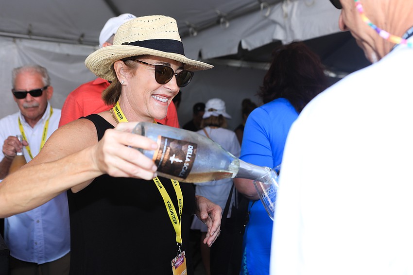 Debbie Anlauf pours champagne for guests.