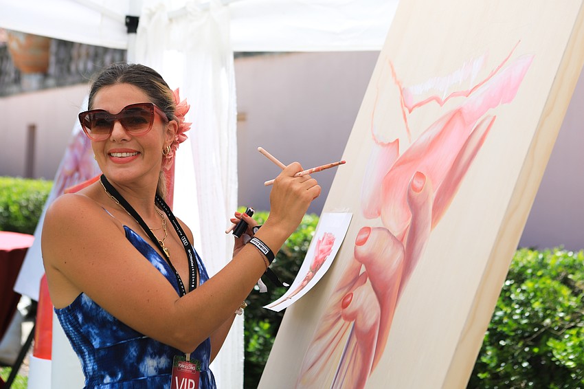 Lipstick Lex paints in the VIP area.