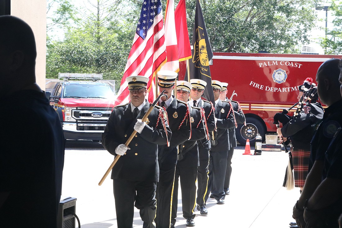The Palm Coast Fire DePartment Honor Guard marches into Fire Station 21 to present the colors for the 50th Anniversary Ceremony. Photo by Brent Woronoff