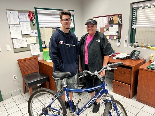 Parker Dixon and Vanessa DeMatteis with the bicycle she gave him.