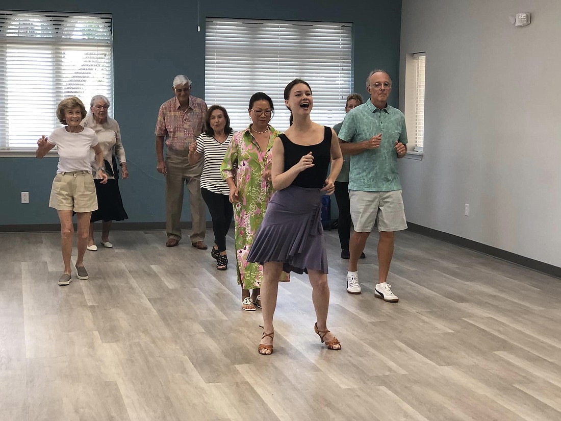 Amber Austin, owner and founder of South Florida Ballroom, leads a private dance lesson at the Paradise Center.