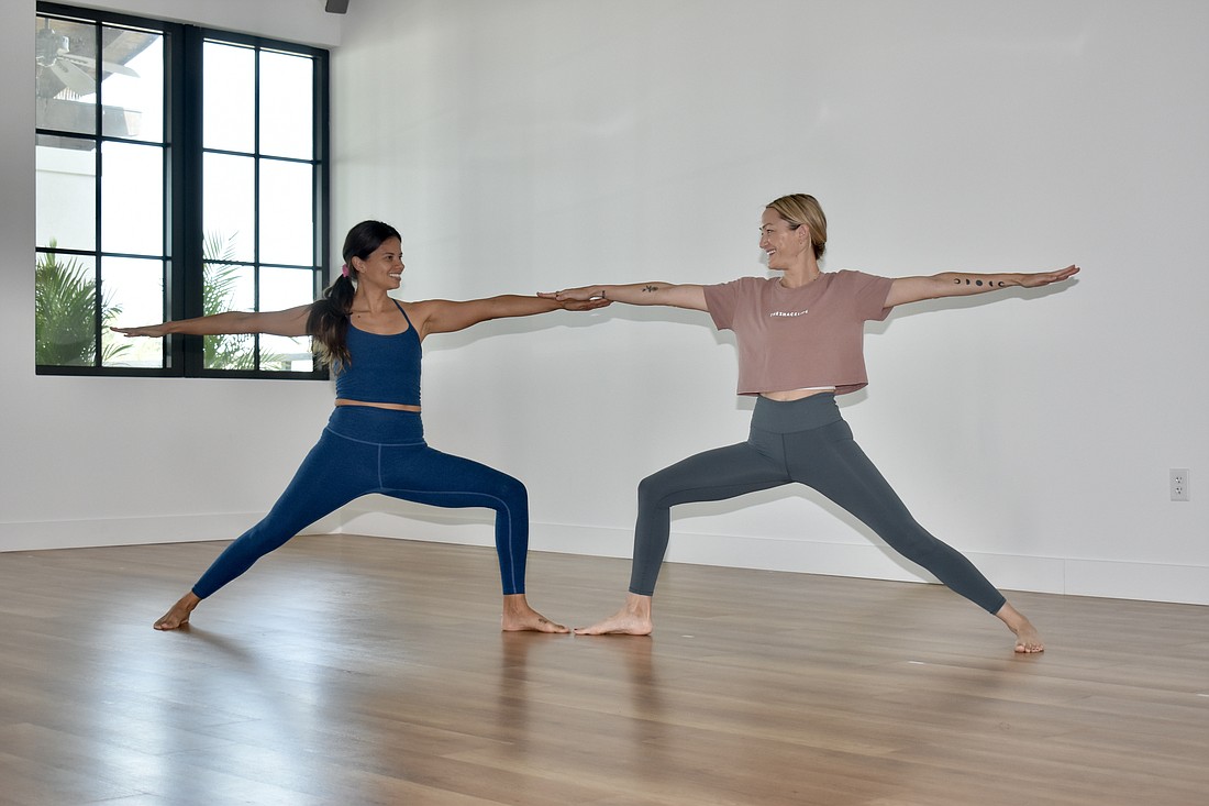 Nikka Colorado and Courtenay Smith strike a yoga pose in their new Waterside Place studio.
