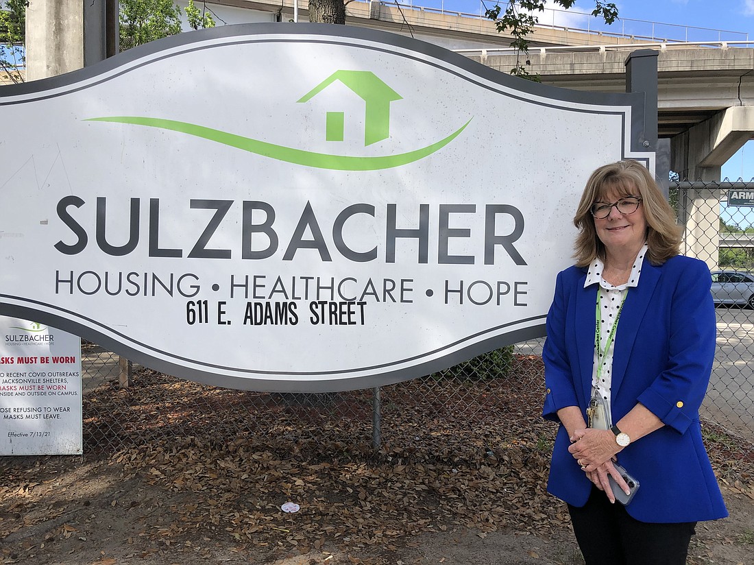 Cindy Funkhouser, president and CEO of Sulzbacher, stands at the entrance to Sulzbacher’s Downtown facility at 611 E. Adams St.