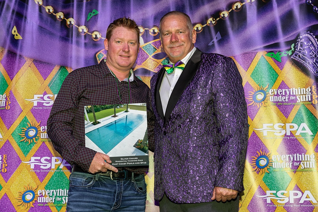 Tom Gilbert accepts the silver award on behalf of East Coast Pools and Spas. Photo courtesy of Florida Swimming Pool Association