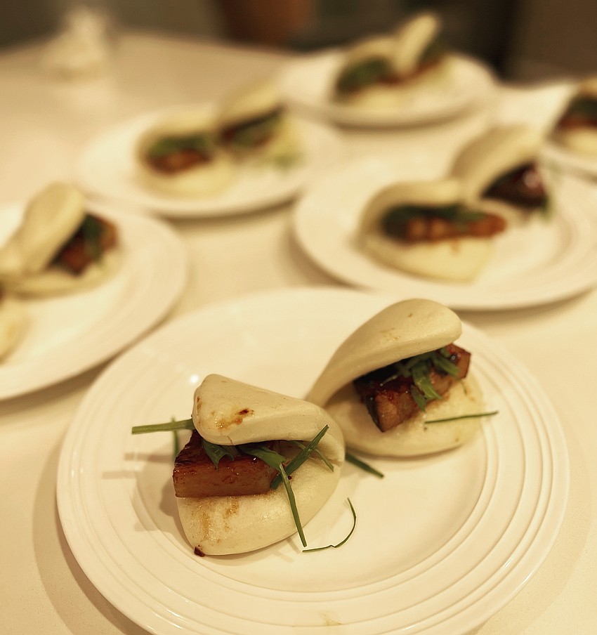 Chef Wu's Sous Vide pork belly in a handmade bao with sliced leek and hoisin sauce.