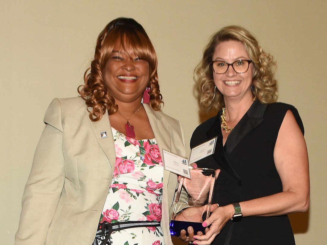 Jacksonville Daily Record Lawyer of the Year Melina Buncome, left, and Daily Record Publisher Angela Campbell.