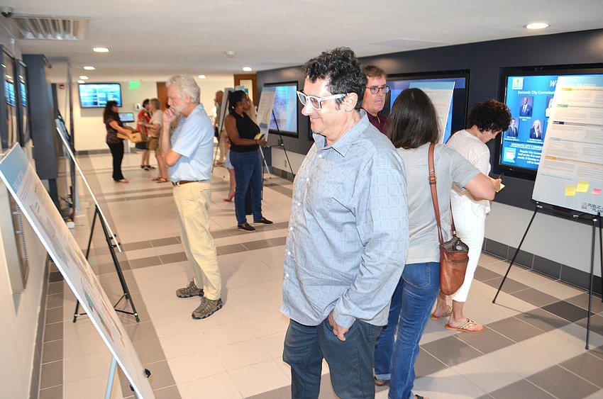 Viktor Mitic looks over display boards highlighting elements of the proposed Sarasota Public Art Plan 2030.