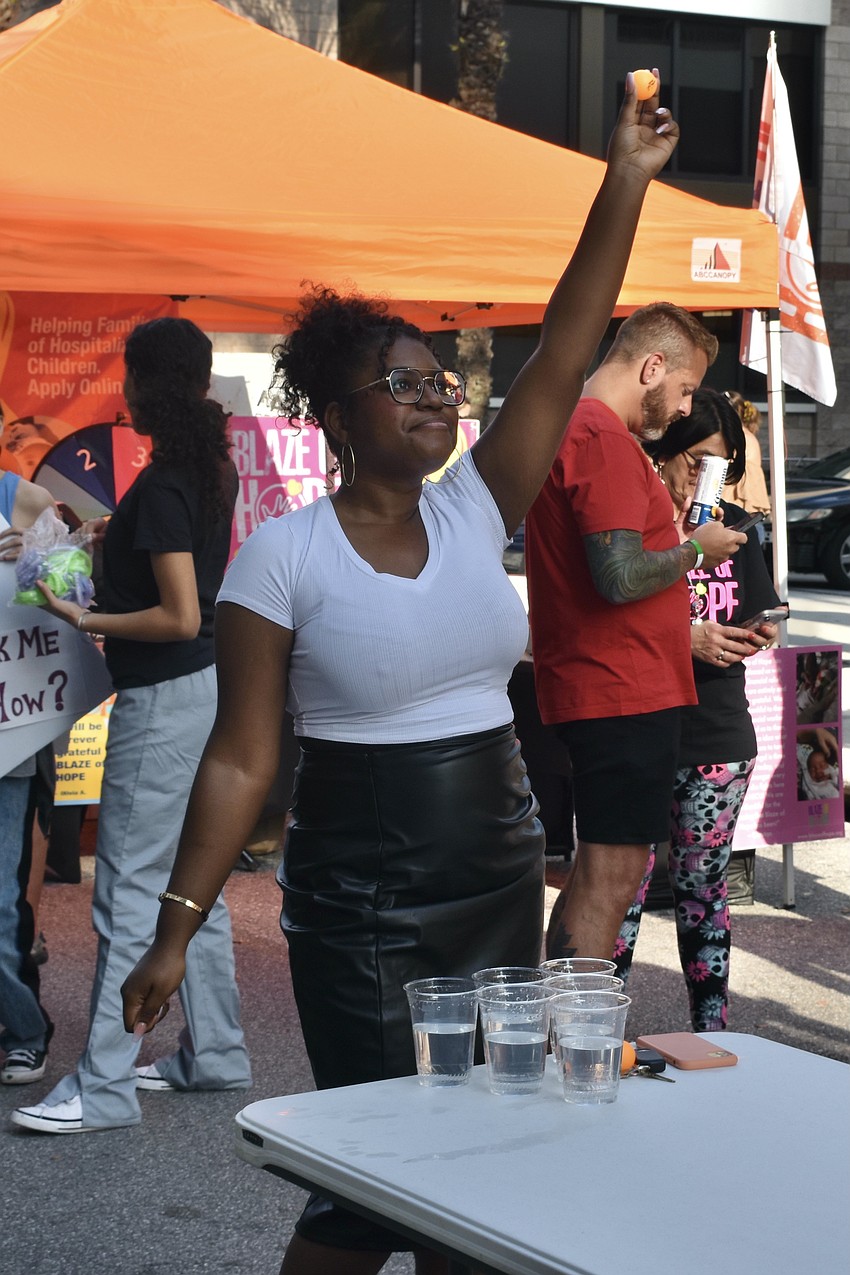 Amber Myers prepares to make a toss in beer pong at the Circo event.