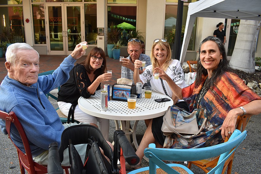 Joe Fleming, Ginny Wezwick, Lee Herron, Carol Herron, and Tamar Hurwitz-Fleming sit down for drinks at the Circo event.