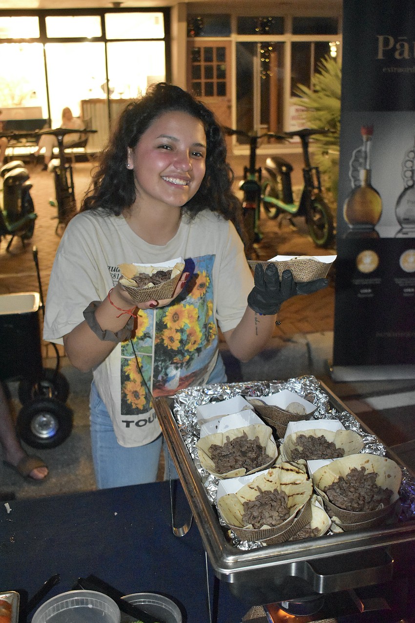 Summer Blanco of AzulSRQ offers up tacos at the Fresh Fridays event