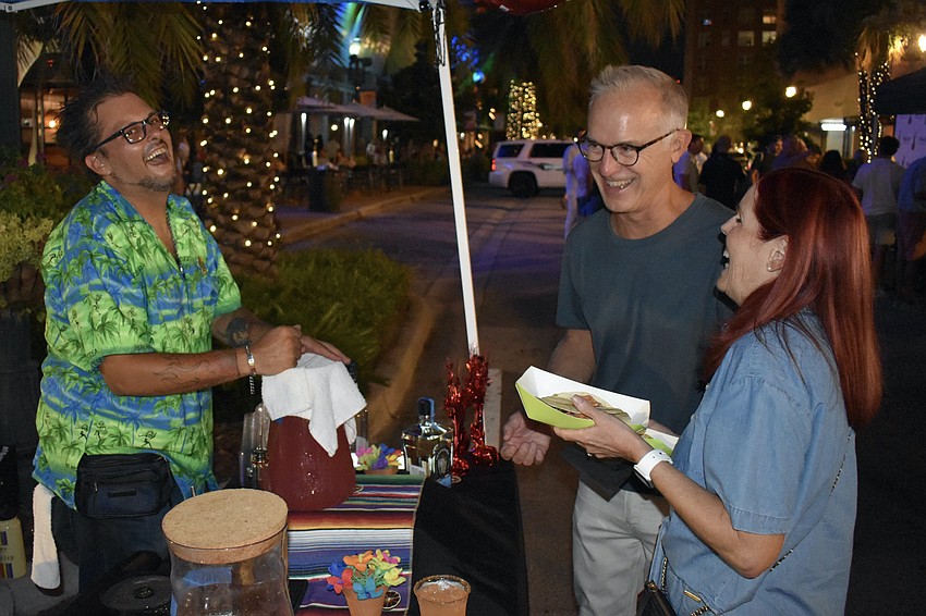 Jospeh Russell of State Street serves Bill and Kathy Waddill at the Fresh Fridays event