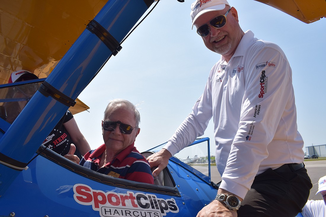 Peter Moore, a Cypress Springs Gracious Retirement Living resident and Navy veteran, and Darryl Fisher, the founder and president of Dream Flights, are ready to take to the skies in a Boeing-Stearman biplane.