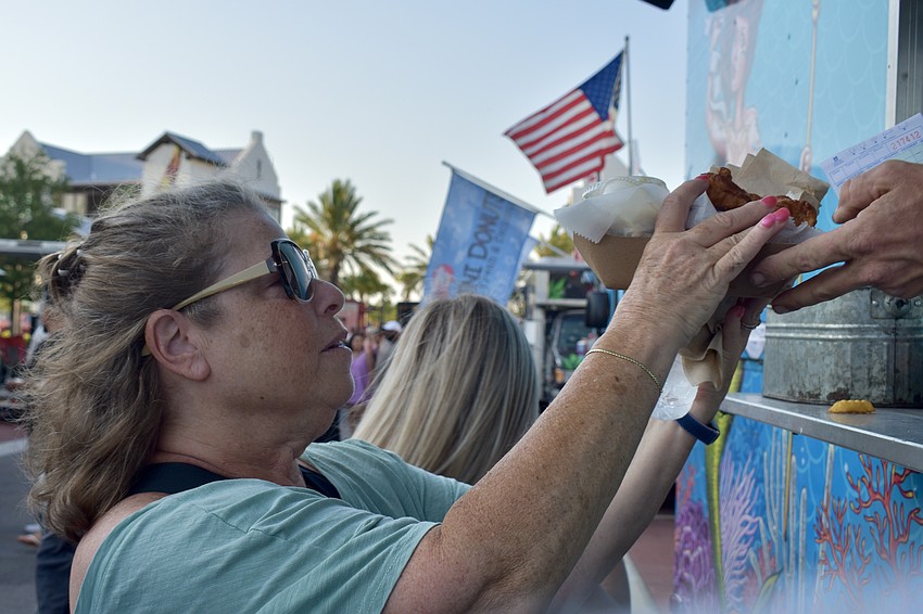Lakewood Ranch resident Cindy Picaus gets fish and chips from the Surly Mermaid truck.