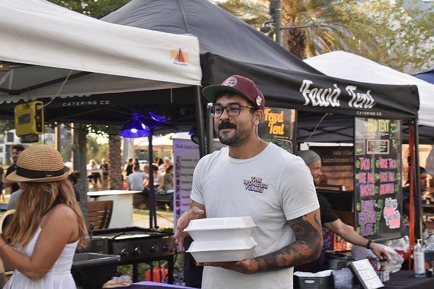 Lakewood Ranch resident Duncan Pressey leaves the Fewd Tent truck with tacos.