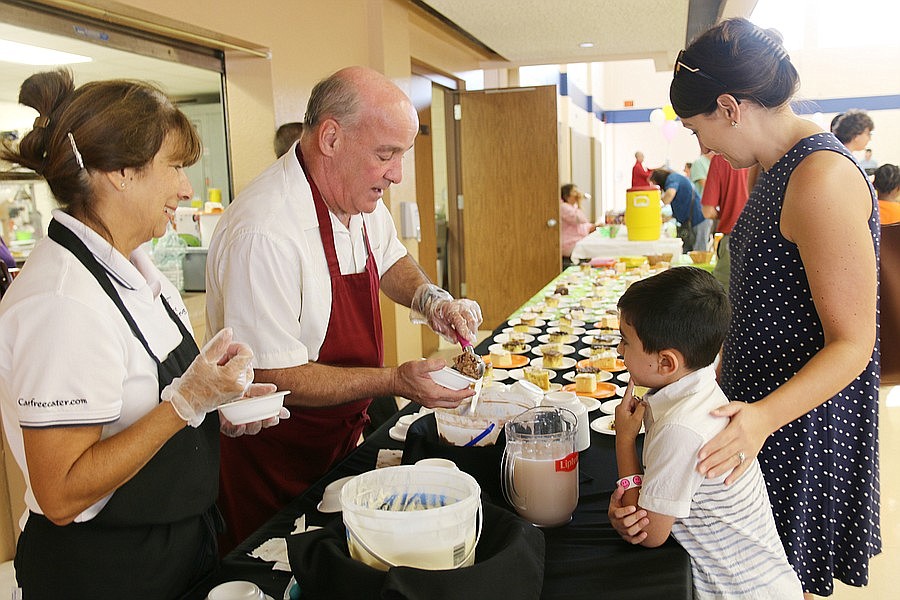 Carol and David Sheperd serve ice cream to Owen and Jessica Blumenfield during the 30th annual Family Renew Ice Cream Social. File photo by Jarleene Almenas