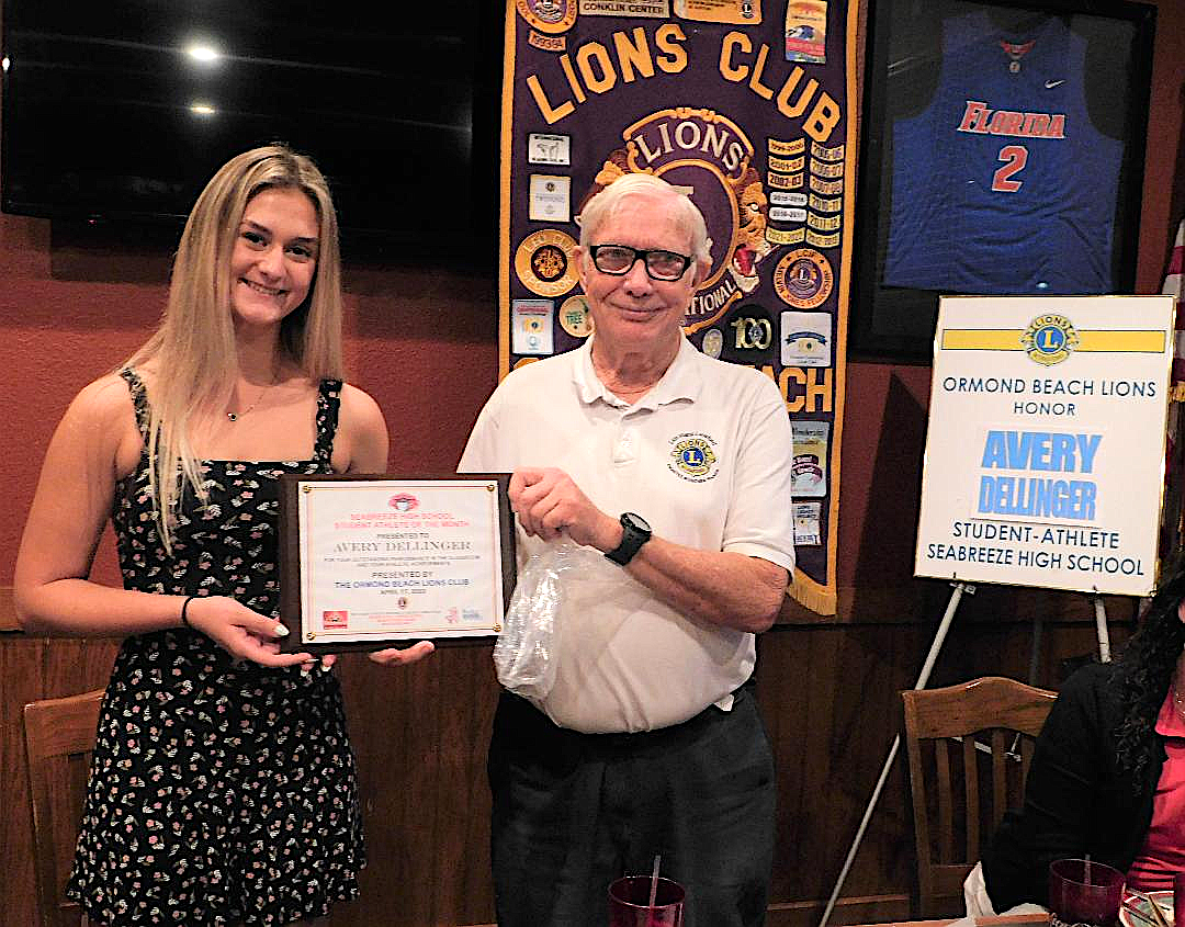 Avery Dellinger receives a plaque from Ormond Beach Lions Club President Hank Lunsford honoring her as the Ormond Beach Lions Club April Student Athlete of the Month.