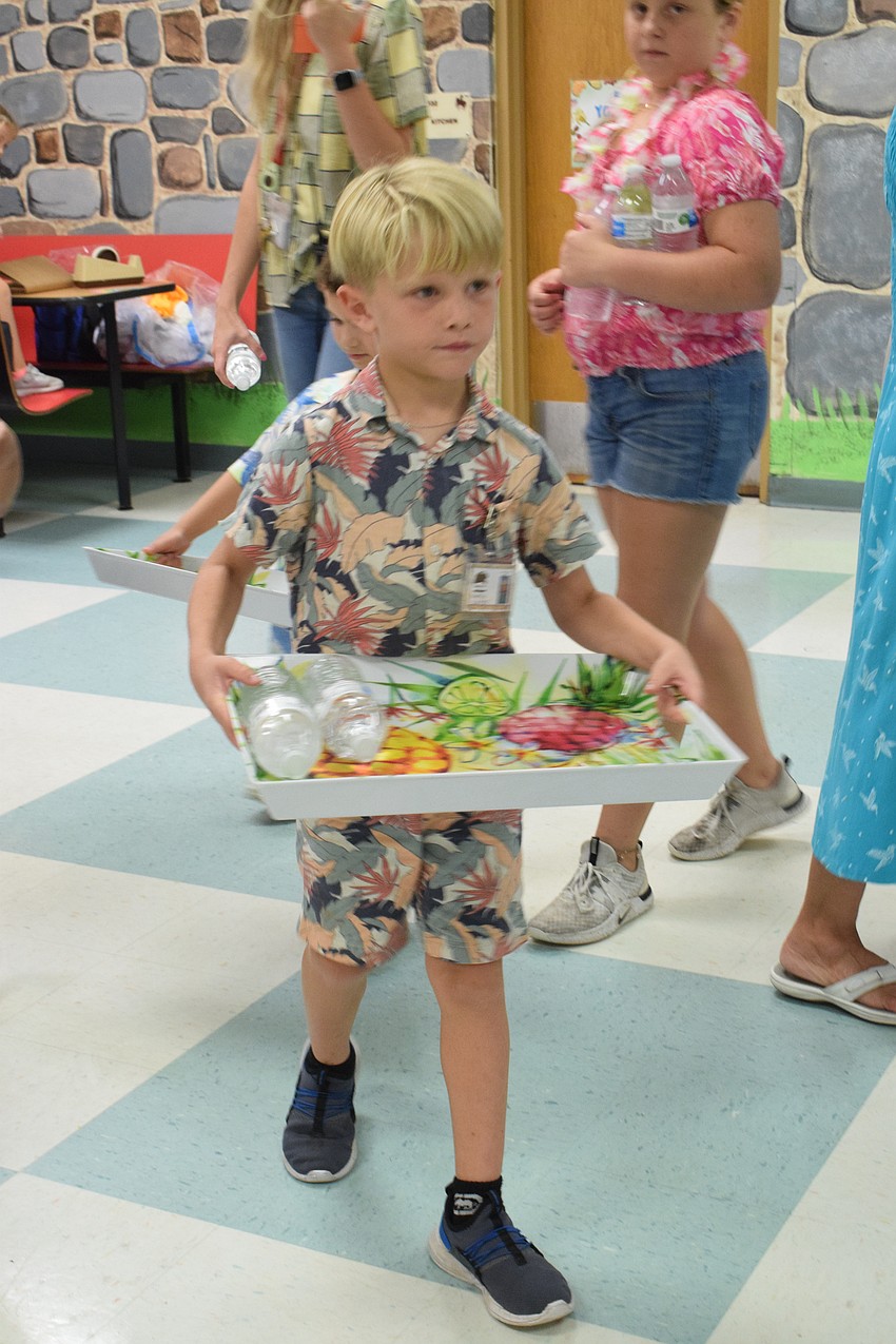 Kindergartner Brantley Emmons takes his job as a waiter seriously.