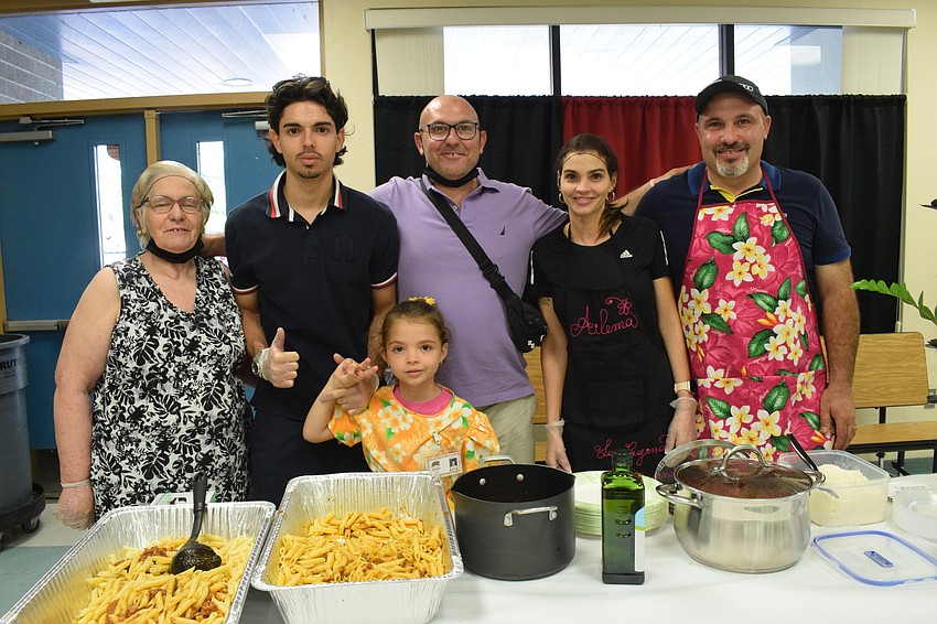 Giuseppina Delia, Jorge Delia, Alice Delia, Vito Delia, Ailema Ibarra and Francesco Delia serve homemade penne al ragu with meat.