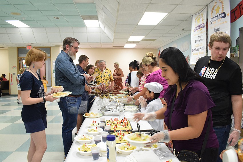 A steady line of customers comes through the Banana Leaf Restaurant.
