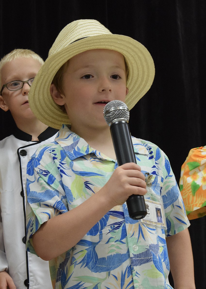 Kindergartner Lgoan Johnson sings a solo during his class' performance of 