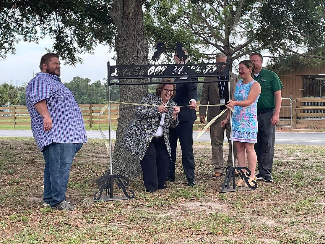 Kelli Kennedy with the School District of Manatee County's Adult, Career and Technical Education department cuts the ribbon to Lakewood Ranch High School's upgraded agriculture lab.