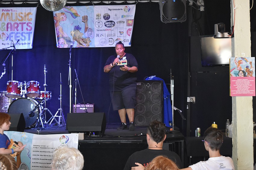 Keynote Speaker Yoleidy Rosario-Hernandez reads a pledge to the audience.