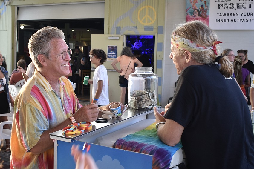 Steve McAllister buys ice cream from Rick Almarode, owner of Ben & Jerry's in Sarasota.