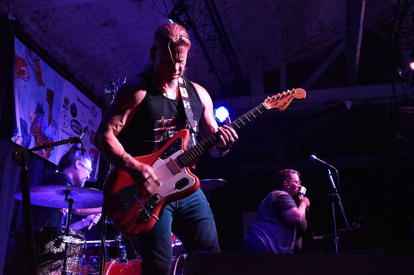 MeteorEYES member George Bikos plays guitar.