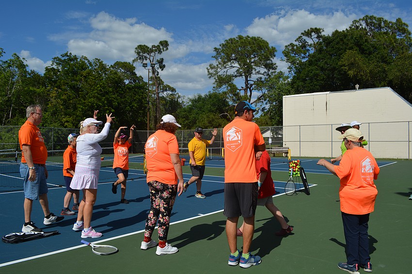 Stacey Allerton, volunteer coach, leads warmup before starting the clinic at Arlington Park for Tennis For Fun.