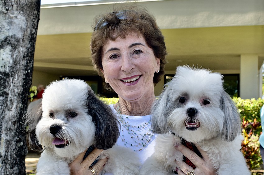 Barbara Brizdle holds her twin dogs, Moxi and Mazy