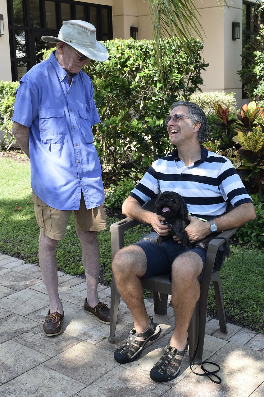 Jack Feldstein's dog Quincy is blessed by Rabbi Brenner Glickman.