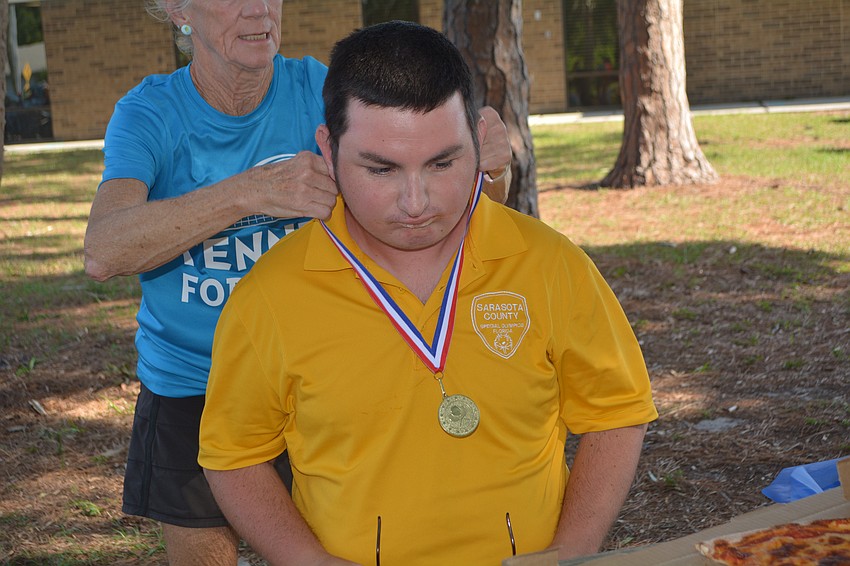 Dylan Mayes receives a medal at the goodby party.