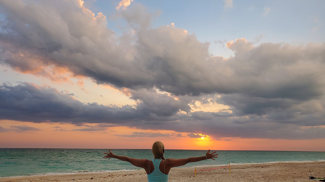 Yoga instructor Angela Mali embraces the last of the sun's rays.