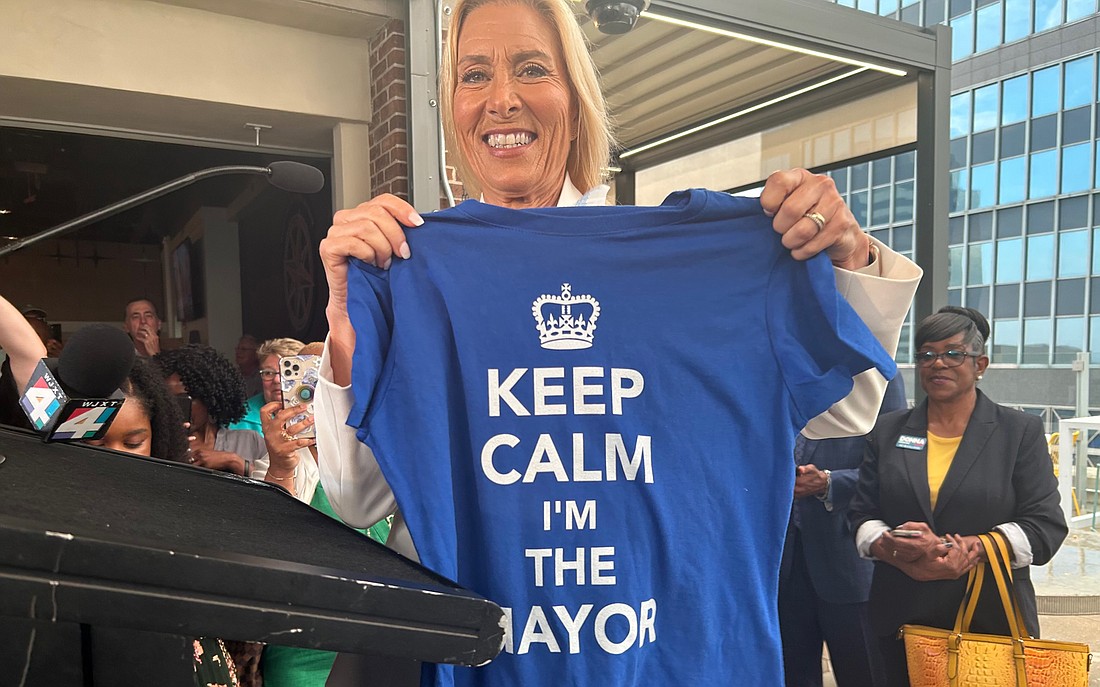 Mayoral-elect Donna Deegan shows off a victory T-shirt at her election watch party May 16 at Estrella Cocina Downtown in the VyStar Credit Union campus.