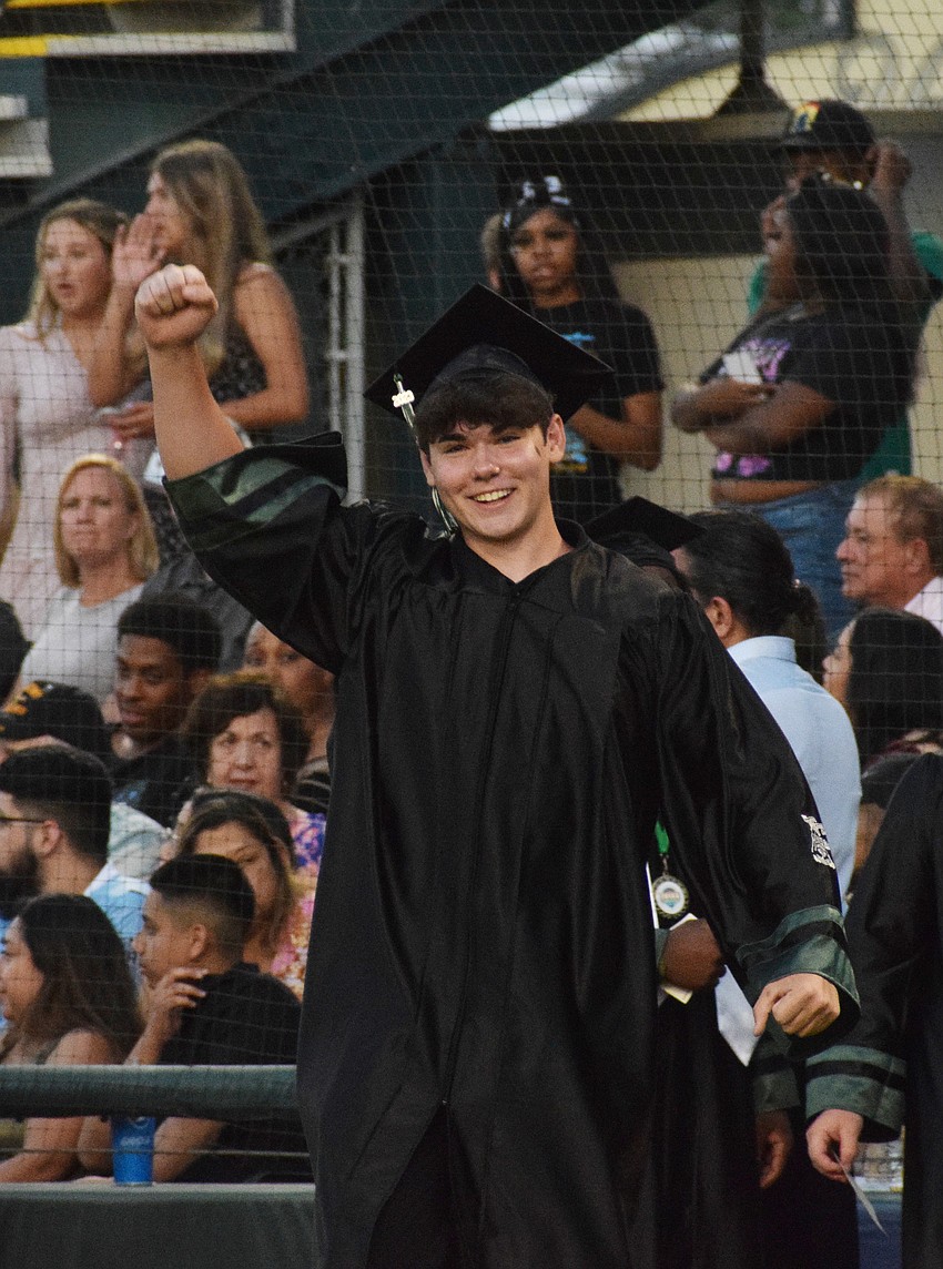 Lakewood Ranch High's Edwin Ennis cheers before he gets his diploma.