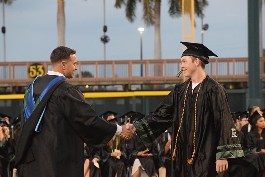 Lakewood Ranch High Assistant Principal Thomas Bellantonio congratulates Sam Jones.
