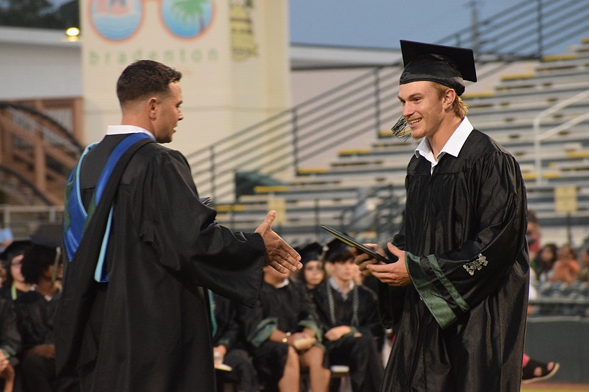 Lakewood Ranch High Assistant Principal Thomas Bellantonio gives Anthony Lenchinsky his diploma.