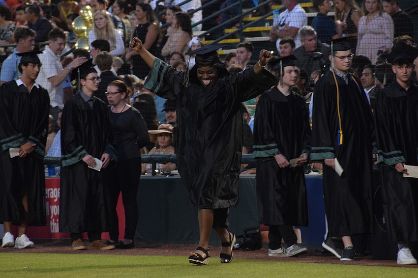 Lakewood Ranch High School's Tamiah Mathews celebrates as she walks to get her diploma.