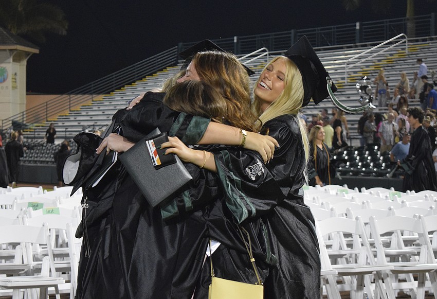 Lakewood Ranch High School graduates Tierney Thornhill, Faith Braun, Serena DePalo and Erika Schmidt join in a group hug after the ceremony.