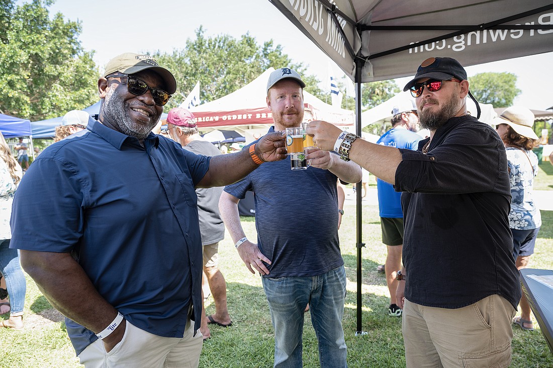 Cheers. Richard Wilson, Jason Devriese and Rod Armstrong sample a variety of beers during the Ormond Beach Beer Festival. Photo by Michele Meyers