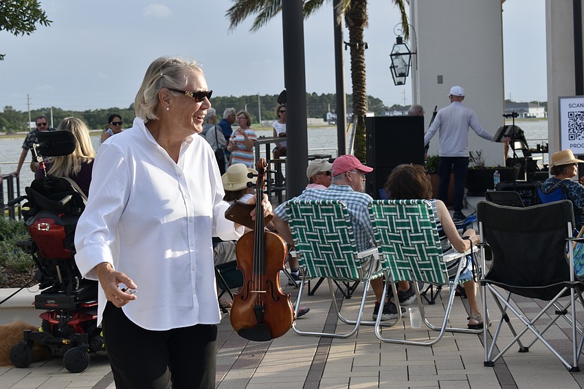 Palm Aire resident and Strings Con Brio member Nancy Dixon spots some friends in the audience.