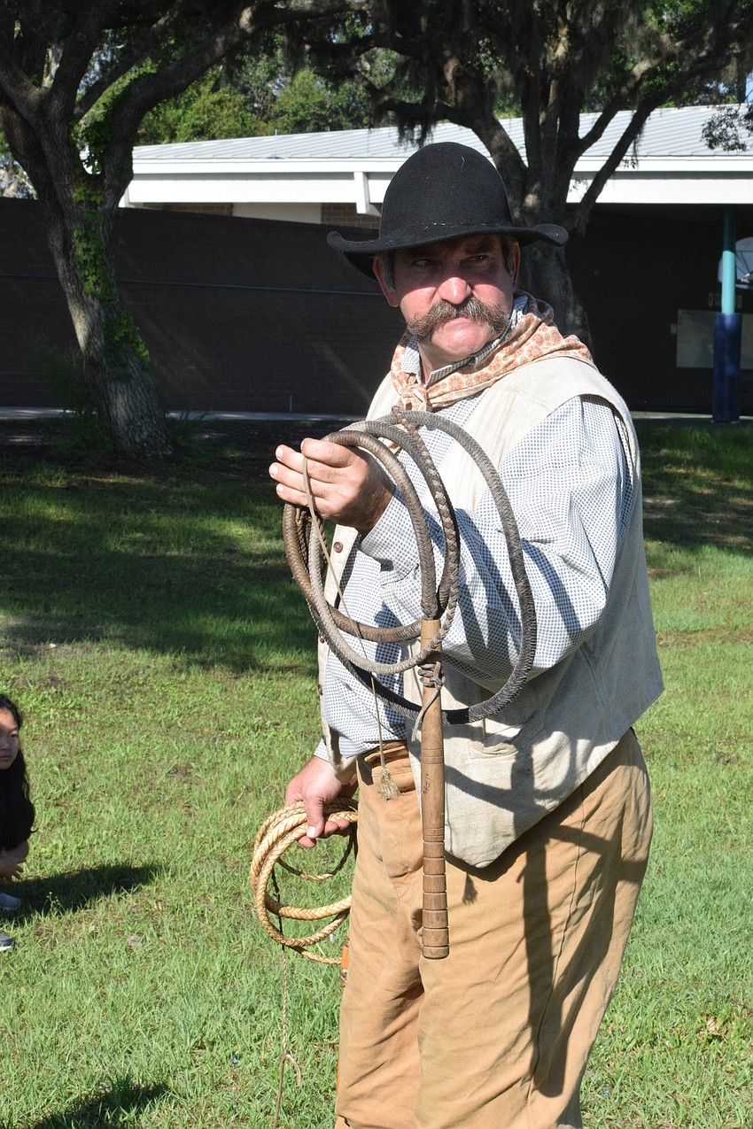 Jim McAlister talks to students about cow whips.