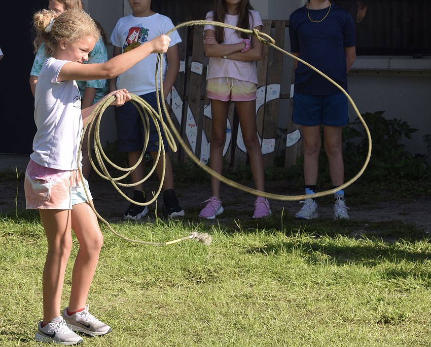 Aliyah Craig, a Gene Witt Elementary School fourth grader, learns how to use a lasso.