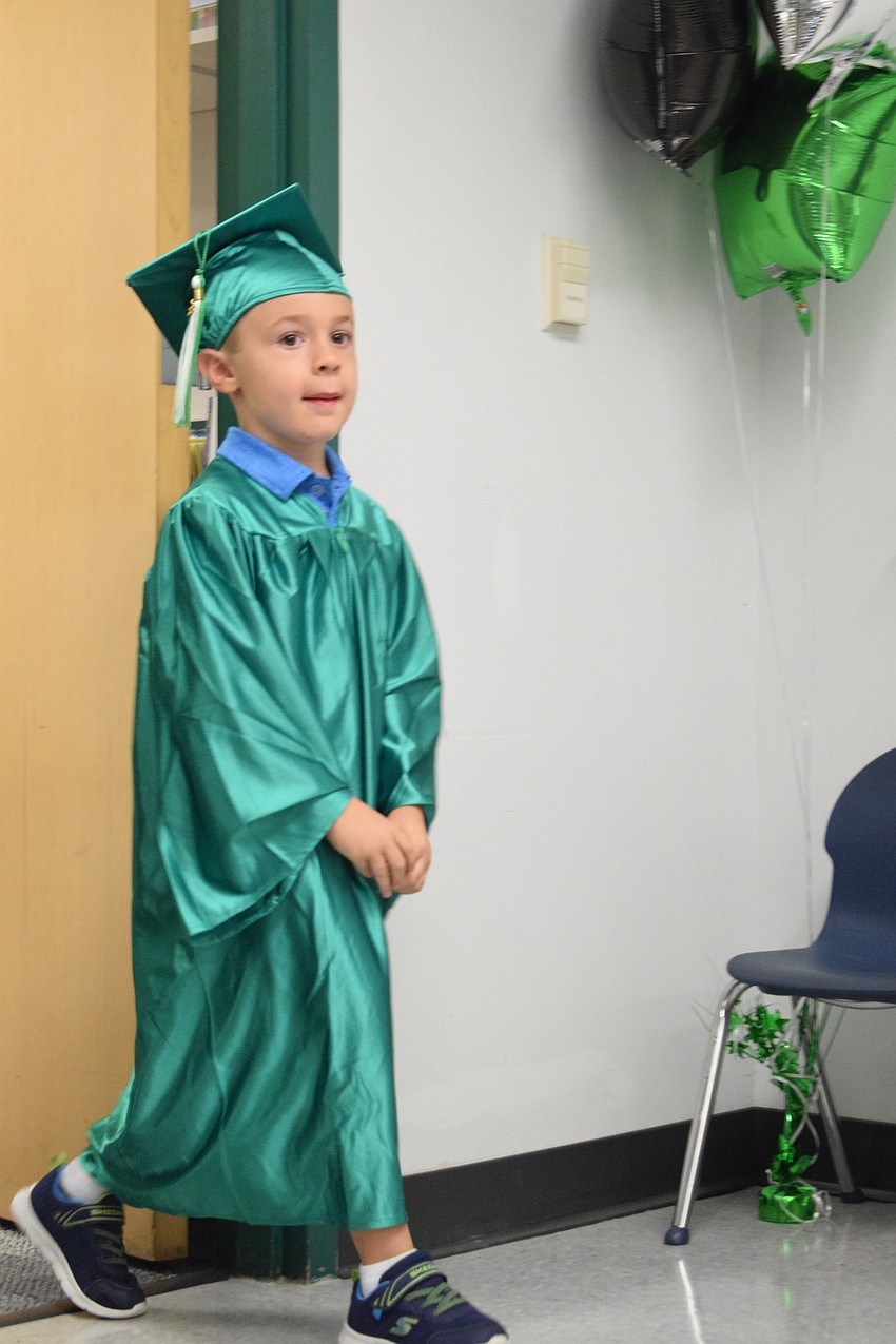Mini Mustangs' Anthony Rossi walks with pride to his seat.