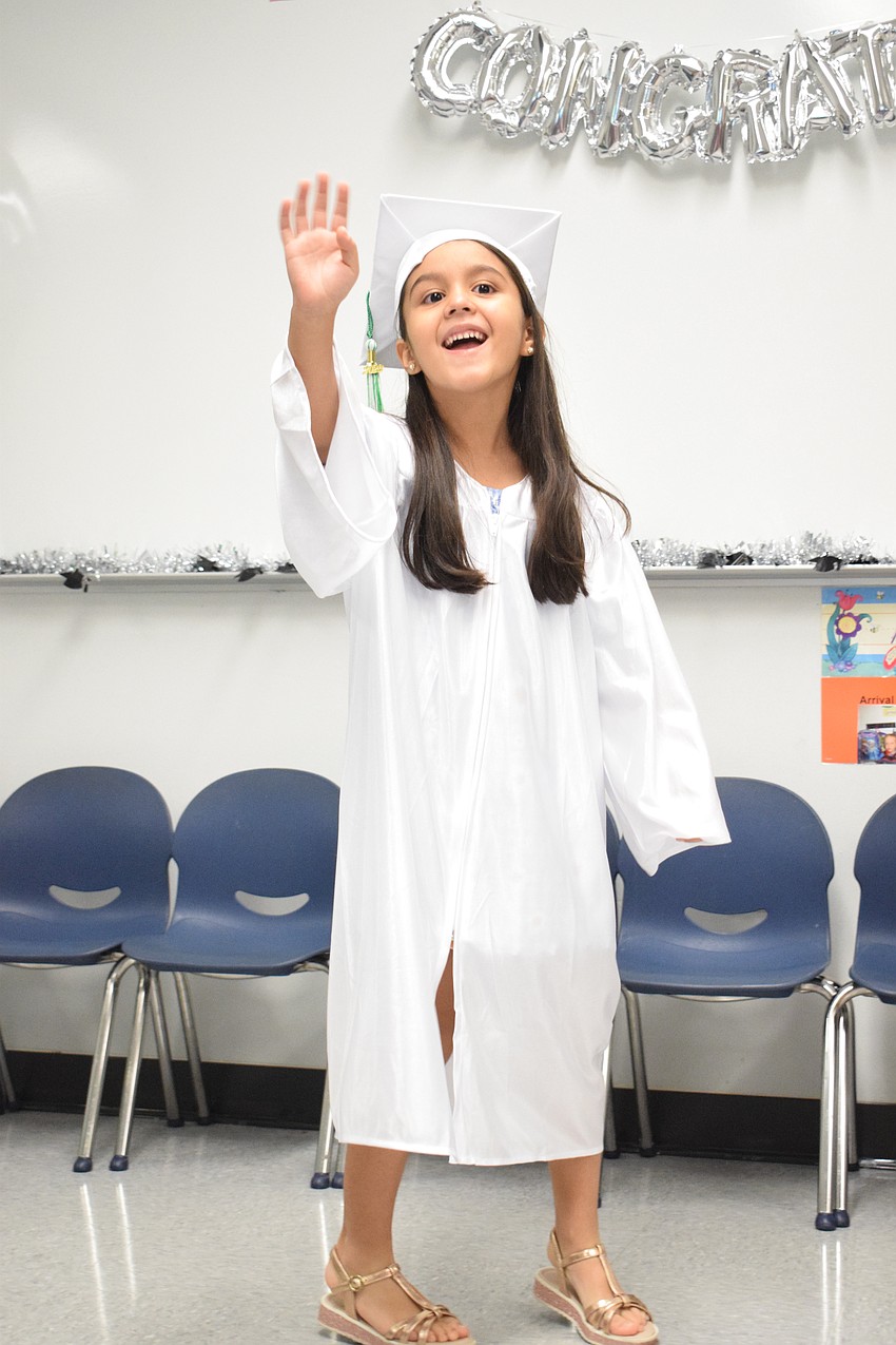Mini Mustangs' Alina Kelly waves to her family.