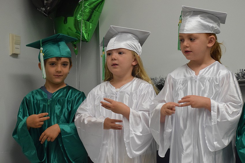Mini Mustangs' Tomas Giromini, Seraphina Michael and Savannah Cato perform a song.