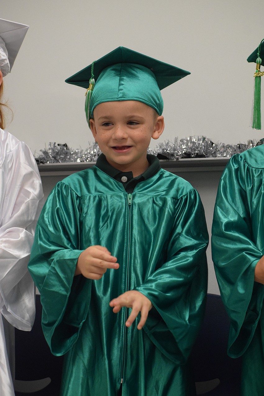 Mini Mustangs' Ruben Mercado sings and signs the words to a song.